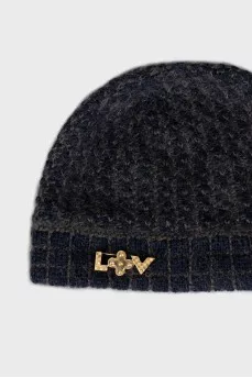 Knitted hat with a golden brooch