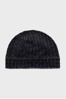 Knitted hat with a golden brooch
