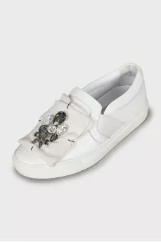 Leather slip-ons decorated with rhinestones