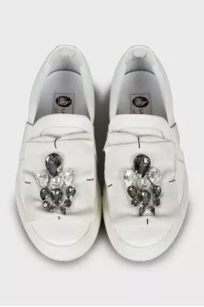Leather slip-ons decorated with rhinestones