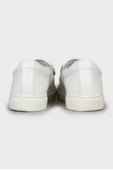 Leather slip-ons decorated with rhinestones