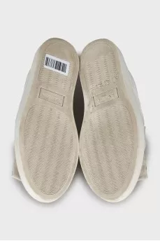 Leather slip-ons decorated with rhinestones