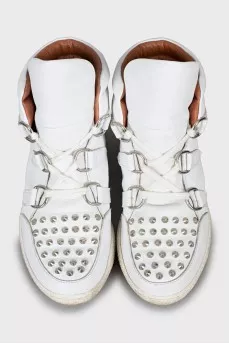 Leather sneakers decorated with spikes