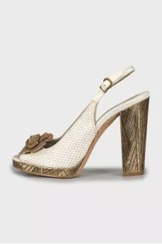 Sandals with metal heel decoration