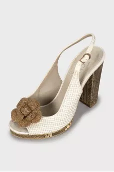 Sandals with metal heel decoration