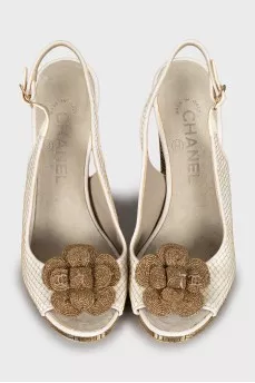 Sandals with metal heel decoration