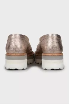 Gold loafers with embossed leather