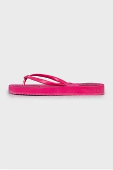 Pink flip flops with brand logo