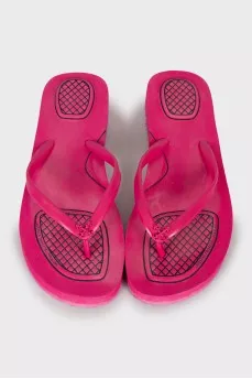 Pink flip flops with brand logo