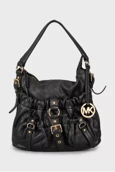 Leather bag decorated with straps