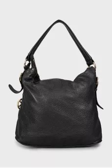 Leather bag decorated with straps