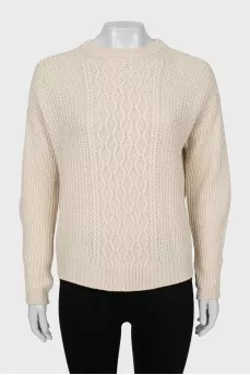 Beige sweater with a relief pattern