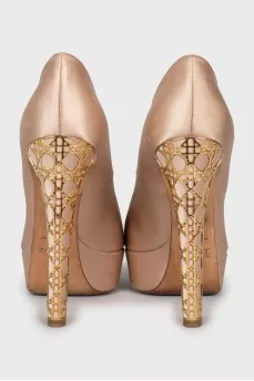 Shoes with gold decor on the heel