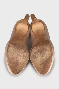 Shoes with gold decor on the heel