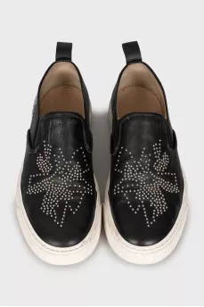 Leather slip-ons with metal decor