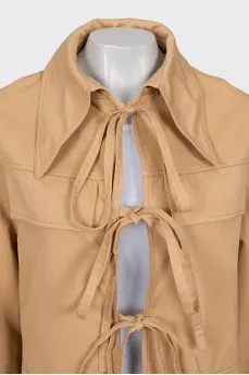 Beige trench coat with ties