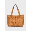 Leather bag with signature print