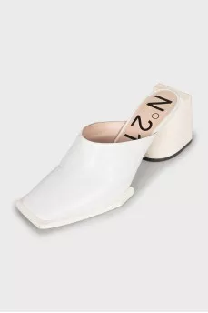 White mules with a figured heel