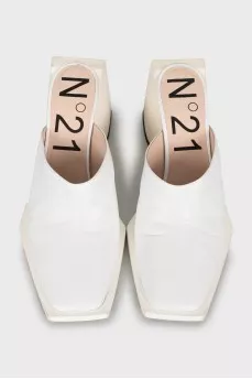 White mules with a figured heel