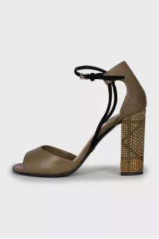 Sandals with gold-tone decor on the heel