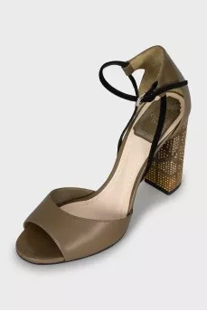 Sandals with gold-tone decor on the heel