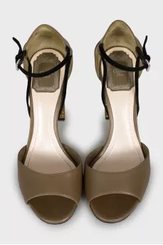 Sandals with gold-tone decor on the heel
