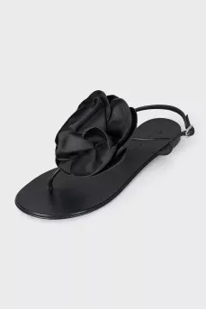 Black sandals decorated with a flower