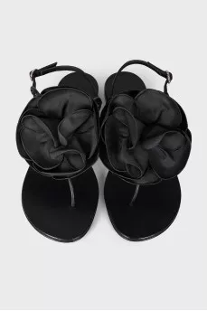 Black sandals decorated with a flower