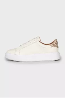 White sneakers with branded logo on the back