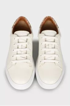 White sneakers with branded logo on the back