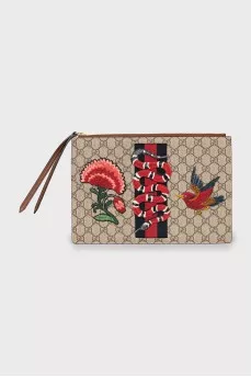 Leather and canvas clutch decorated with patches