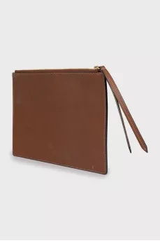 Leather and canvas clutch decorated with patches