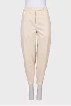 Beige trousers with relief seams