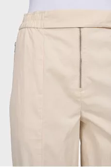 Beige trousers with relief seams