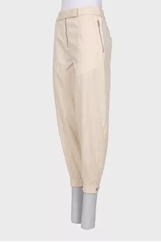 Beige trousers with relief seams