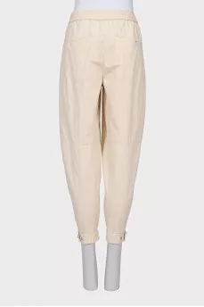 Beige trousers with relief seams