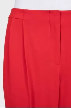 Red trousers with arrows and tag