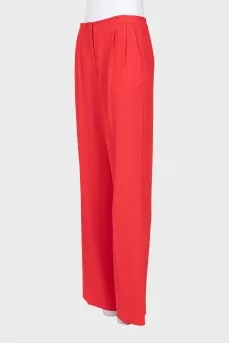 Red trousers with arrows and tag