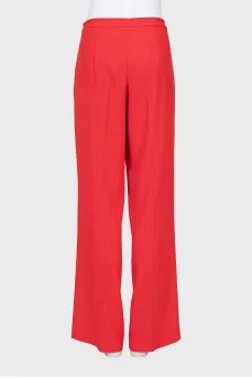 Red trousers with arrows and tag