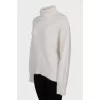 Knitted white turtleneck sweater