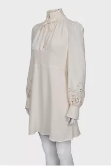 Dress with perforated sleeves