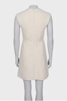 White dress with golden pin