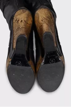 Leather over-the-knee boots with a gold wedge heel