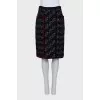 A suit consisting of a jacket and skirt with velvet trim