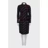 A suit consisting of a jacket and skirt with velvet trim