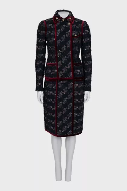 A suit consisting of a jacket and skirt with velvet trim