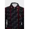 A suit consisting of a jacket and skirt with velvet trim