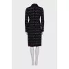 A suit consisting of a jacket and skirt with velvet trim