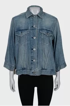 Denim jacket decorated with zippers