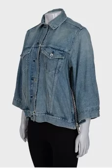 Denim jacket decorated with zippers